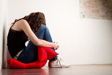 Sad girl crying on corner