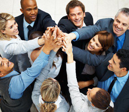Group of executives placing their hands together